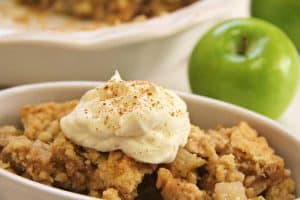 Apple crisp in a bowl with an apple